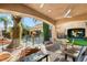 Inviting outdoor patio area featuring a covered seating area overlooking a pool, perfect for relaxation and entertaining at 8455 Stange Ave, Las Vegas, NV 89129
