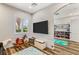 Bright playroom with a window, built-in shelves with a variety of toys, and wood-like floors at 8455 Stange Ave, Las Vegas, NV 89129