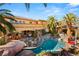 Expansive backyard featuring a custom pool with a swim-up bar, waterfall, and a spacious outdoor dining area at 8455 Stange Ave, Las Vegas, NV 89129