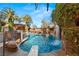 Beautiful pool featuring a unique rock waterfall, lush landscaping, and poolside seating for relaxing and entertaining at 8455 Stange Ave, Las Vegas, NV 89129