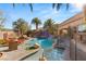 Stunning pool area with waterfall feature, surrounded by lush landscaping and comfortable lounge seating, perfect for outdoor enjoyment at 8455 Stange Ave, Las Vegas, NV 89129