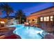 Inviting pool area with a rock waterfall, fire feature, and palm trees, creating a relaxing oasis for outdoor enjoyment at 8455 Stange Ave, Las Vegas, NV 89129