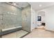 Large walk-in shower featuring glass doors and rainfall shower head with a bench and mosaic tile wall at 8455 Stange Ave, Las Vegas, NV 89129