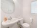 Half bathroom with pedestal sink, toilet, and simple decor at 9132 Gabardine Ave, Las Vegas, NV 89149