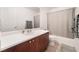Bathroom with a single sink vanity with a white countertop and wooden cabinets at 9132 Gabardine Ave, Las Vegas, NV 89149