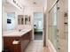 Clean bathroom featuring wood vanity, ample counter space and shower-tub combo at 9132 Gabardine Ave, Las Vegas, NV 89149