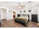 Spacious bedroom with hardwood floors, ceiling fan, and art-filled walls at 9132 Gabardine Ave, Las Vegas, NV 89149