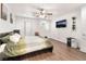 Bright bedroom with hardwood floors, ceiling fan, and sliding glass door to patio at 9132 Gabardine Ave, Las Vegas, NV 89149