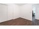 Empty bedroom with wood-style flooring, closet and an entrance to another room at 9132 Gabardine Ave, Las Vegas, NV 89149