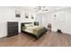Well-lit bedroom with a ceiling fan, hardwood floors, and a minimalist design at 9132 Gabardine Ave, Las Vegas, NV 89149