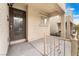 Cozy, covered front porch with decorative iron railing and a stylish front door that welcomes guests at 9132 Gabardine Ave, Las Vegas, NV 89149