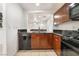 Functional kitchen with stainless steel appliances, dark countertops, and an open layout to the living area at 9132 Gabardine Ave, Las Vegas, NV 89149