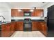 Well-equipped kitchen boasting wood cabinets, black appliances, and plenty of counter space for meal preparation at 9132 Gabardine Ave, Las Vegas, NV 89149