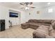 Cozy living room with large sectional sofa, ceiling fan, and water cooler at 9132 Gabardine Ave, Las Vegas, NV 89149