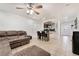Spacious living room with tile floors, a large couch and view of the dining area at 9132 Gabardine Ave, Las Vegas, NV 89149
