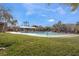 Community swimming pool surrounded by lounge chairs and beautiful landscaping at 9132 Gabardine Ave, Las Vegas, NV 89149