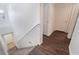 Carpeted staircase with wood floors on the landing and an adjacent bathroom at 9132 Gabardine Ave, Las Vegas, NV 89149