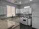 Well-appointed kitchen with granite counters, white cabinets, and modern appliances, creating a functional space at 9592 Villa Calera Ave, Las Vegas, NV 89148