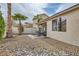 A backyard patio with desert landscaping and palm trees at 9844 Altadena St, Las Vegas, NV 89183