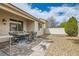 Backyard patio with desert landscaping, featuring a dining table and chairs at 9844 Altadena St, Las Vegas, NV 89183