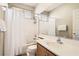 Bathroom featuring a bath tub with shower, large mirror, and modern faucet at 9844 Altadena St, Las Vegas, NV 89183