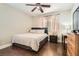 Comfortable bedroom with hardwood floors, a cozy bed, and natural light from the window at 9844 Altadena St, Las Vegas, NV 89183