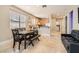 Open concept dining area featuring travertine floors, neutral walls, and kitchen access at 9844 Altadena St, Las Vegas, NV 89183