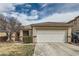 Charming single-story home featuring a two-car garage and desert landscaping under a cloudy sky at 9844 Altadena St, Las Vegas, NV 89183