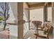 Cozy front porch with rocking chairs, textured columns, and a view of the landscaped yard at 9844 Altadena St, Las Vegas, NV 89183