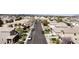 Aerial view of a quiet neighborhood street featuring well-kept homes, mature trees, and neatly landscaped front yards at 9844 Altadena St, Las Vegas, NV 89183