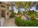 Backyard with manicured landscaping, a water feature, and a glimpse of the home's architecture at 10404 Longwood Dr, Las Vegas, NV 89134