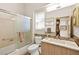 Clean and bright bathroom with updated vanity, shower and bathtub at 10404 Longwood Dr, Las Vegas, NV 89134
