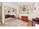 Spacious bedroom showcasing decoratively hung art, light from a window, and hardwood floors at 10404 Longwood Dr, Las Vegas, NV 89134