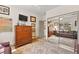 Light bedroom showing a mirrored closet, art covered walls, hardwood floors and a leather sofa at 10404 Longwood Dr, Las Vegas, NV 89134
