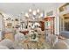 Open concept living with dining area featuring modern lighting and clear view of chef's kitchen at 10404 Longwood Dr, Las Vegas, NV 89134