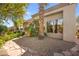 Exterior home view showcasing mature landscaping and gravel ground cover at 10404 Longwood Dr, Las Vegas, NV 89134