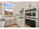Charming kitchen featuring stainless steel appliances and tile backsplash at 10404 Longwood Dr, Las Vegas, NV 89134