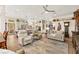 Open-concept living room with a cozy seating area, hardwood floors, and kitchen in the background at 10404 Longwood Dr, Las Vegas, NV 89134
