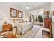 Serene main bedroom with natural light, decorative mirrors, and comfortable furnishings at 10404 Longwood Dr, Las Vegas, NV 89134