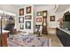 Well-lit office space with a stylish rug, a collection of art, a vintage clock and dark trim at 10404 Longwood Dr, Las Vegas, NV 89134