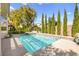 Backyard swimming pool with hot tub, water feature, and privacy landscaping at 10404 Longwood Dr, Las Vegas, NV 89134
