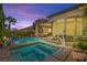 Inviting backyard featuring a sparkling pool and spa, complemented by an outdoor seating area and lush greenery at 10404 Longwood Dr, Las Vegas, NV 89134