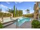 An inviting pool and spa are surrounded by lush greenery and attractive landscaping at 10404 Longwood Dr, Las Vegas, NV 89134