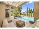Backyard swimming pool with covered patio and tall privacy trees providing lots of shade and seclusion at 10404 Longwood Dr, Las Vegas, NV 89134