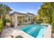 Beautiful backyard featuring a pool with spa, covered patio, and well-maintained landscaping at 10404 Longwood Dr, Las Vegas, NV 89134
