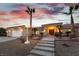 Front exterior featuring desert landscaping, a driveway, and a welcoming entrance to the home at 1056 Calico Ridge Dr, Henderson, NV 89011