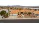 Wide aerial shot of the home's front exterior with beautiful desert landscaping and 3-car garage at 1056 Calico Ridge Dr, Henderson, NV 89011