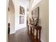 Hallway with archway, wood-look flooring, decorative art, and a console table with art objects at 1056 Calico Ridge Dr, Henderson, NV 89011