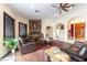 Open-concept living area featuring modern fireplace, decorative art, wood-look flooring, and a ceiling fan at 1056 Calico Ridge Dr, Henderson, NV 89011