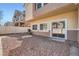 Backyard featuring gravel ground cover, a fence, and a sliding glass door entrance to the home at 1142 Heavenly Harvest Pl # 2, Henderson, NV 89002